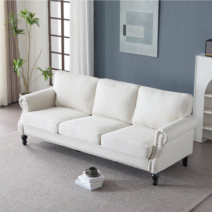 Cream faux leather 83 Inch rolled-arm sofa with nailhead trim and dark turned legs on Tampa Home & Garden Store