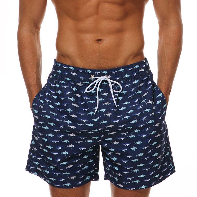 Men's navy blue shark-print boardshorts with white drawstring for quick-dry swimming on Tampa Home & Garden Store
