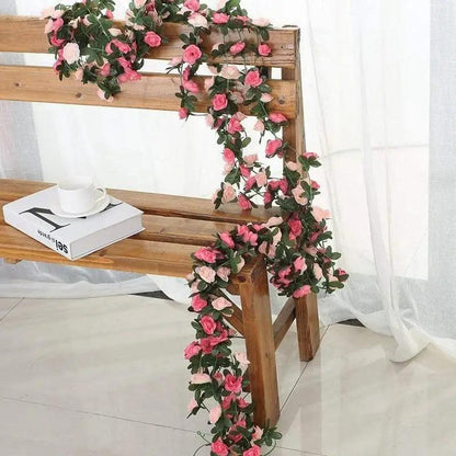 Rose artificial garland 250cm with pink roses and leaves draped over a bench for wedding decor on Tampa Home & Garden Store
