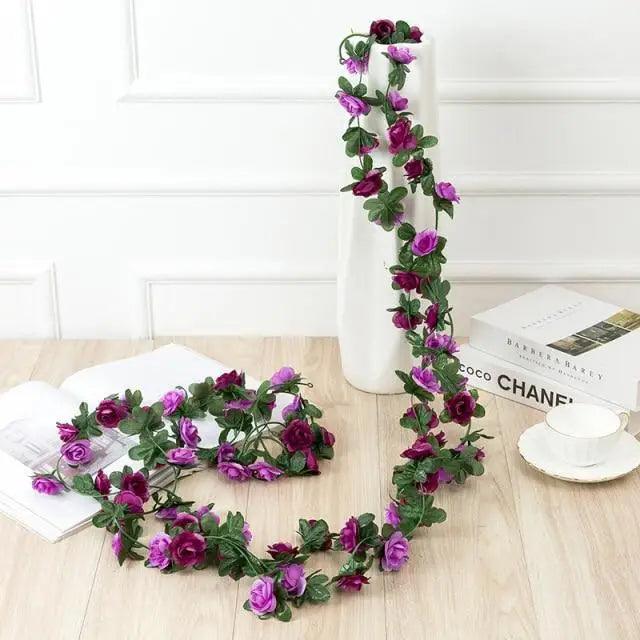 Rose artificial garland 250cm with purple roses and green leaves around a white vase Stevvex on Tampa Home & Garden Store