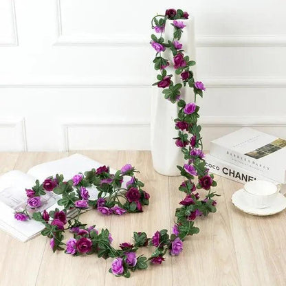 Rose artificial garland 250cm with purple roses and green leaves around a white vase Stevvex on Tampa Home & Garden Store