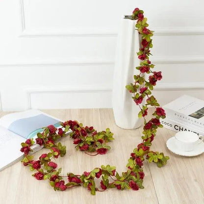 Rose artificial garland 250cm with red roses and green leaves displayed on a white vase Stevvex on Tampa Home & Garden Store