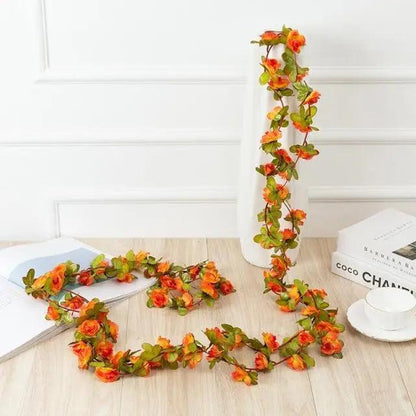 Artificial 250cm rose garland with orange-red blooms and green leaves for wedding decor on Tampa Home & Garden Store