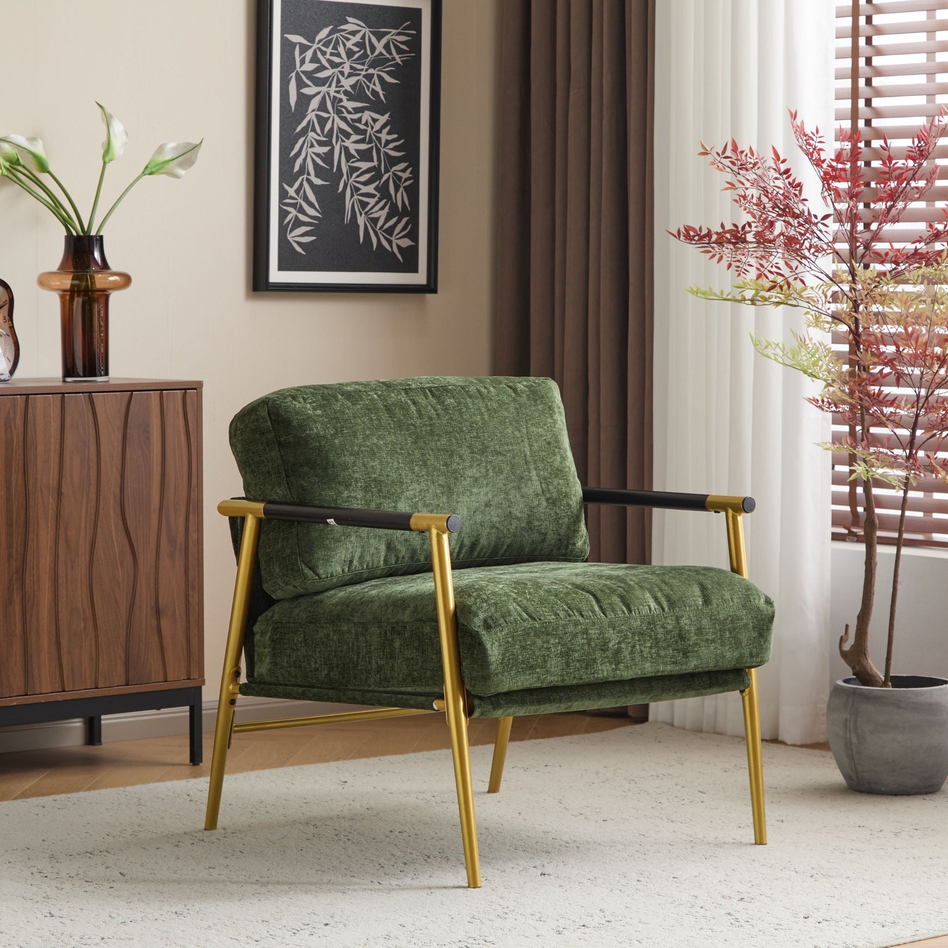Modern accent chair with plush green velvet cushions and a gold metal frame in a stylish living room on Tampa Home & Garden Store