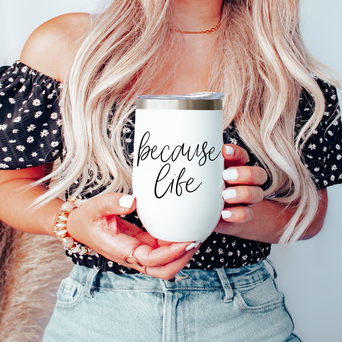 Gia Roma Because Life 17oz tumbler, white insulated cup with silver lid, held by woman on Tampa Home & Garden Store