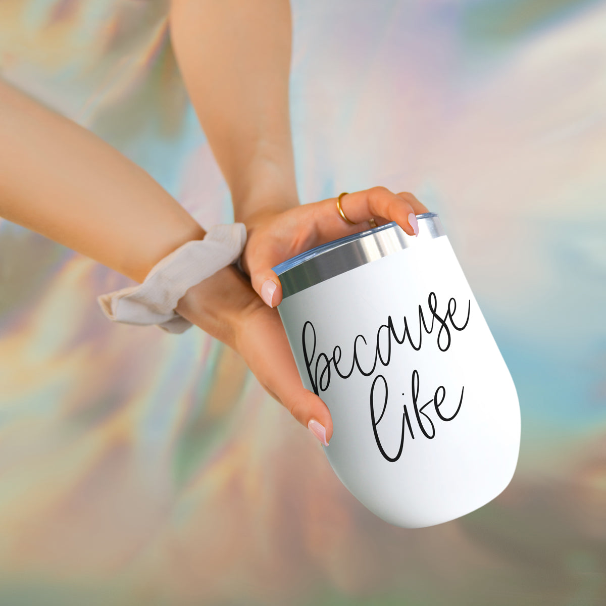 Gia Roma Because Life 17oz tumbler, white stainless steel with black script, held by hand on Tampa Home & Garden Store
