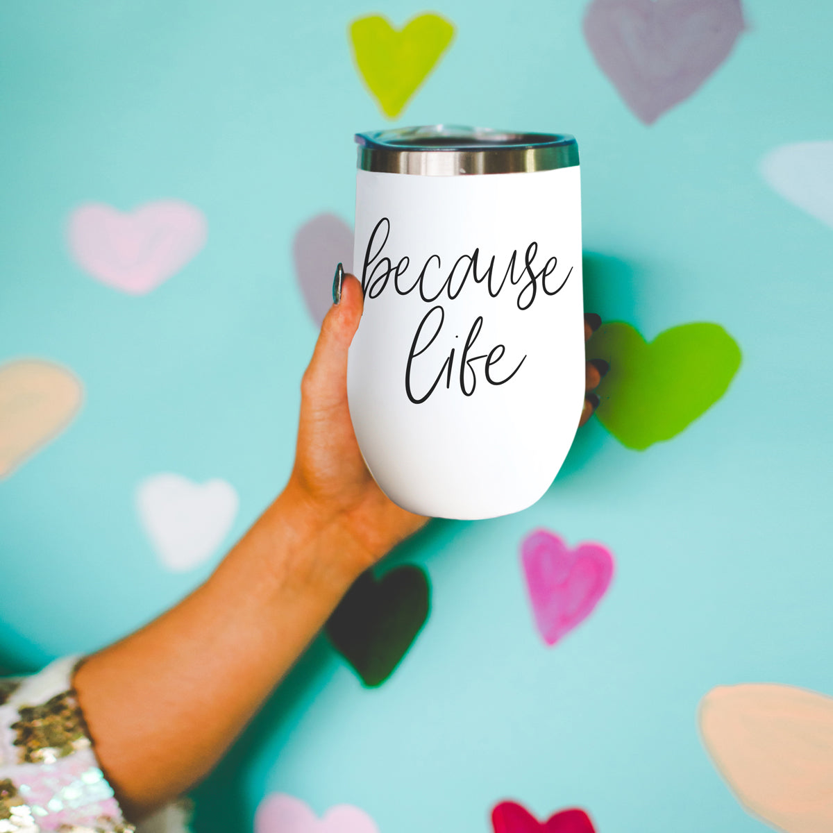 Because Life 17oz tumbler by Gia Roma, white body with metallic lid, held in hand on Tampa Home & Garden Store