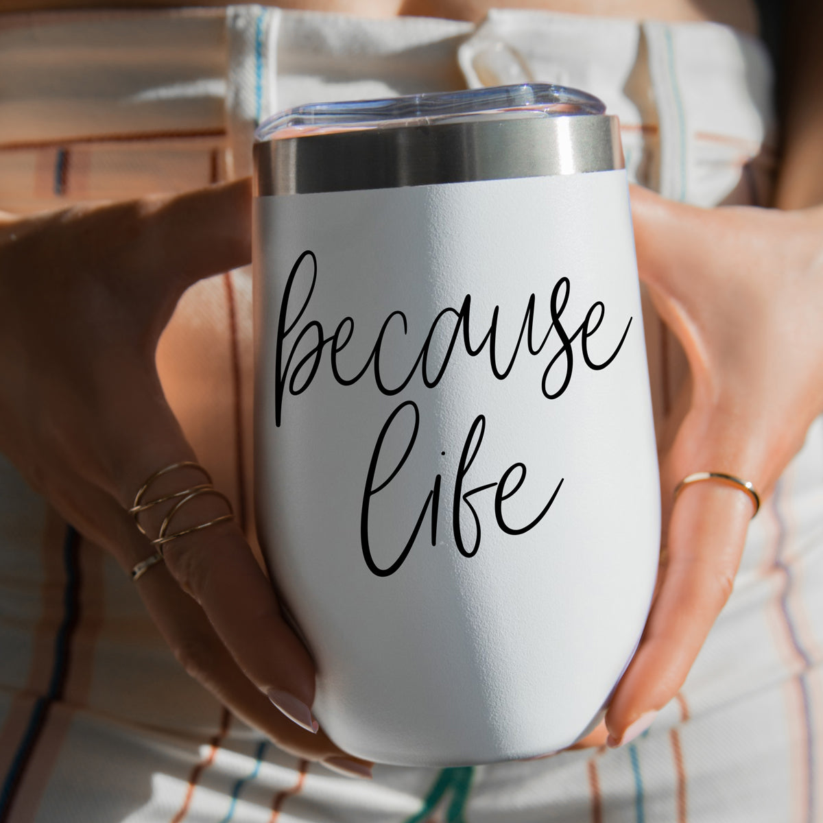 Because Life 17oz tumbler by Gia Roma white with black script and clear lid held by hands on Tampa Home & Garden Store