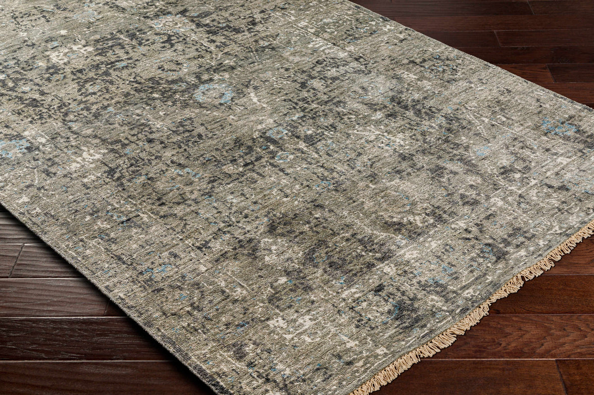 Becerril Premium Rug by Boutique Rugs in distressed gray with blue flecks and fringe on Tampa Home & Garden Store