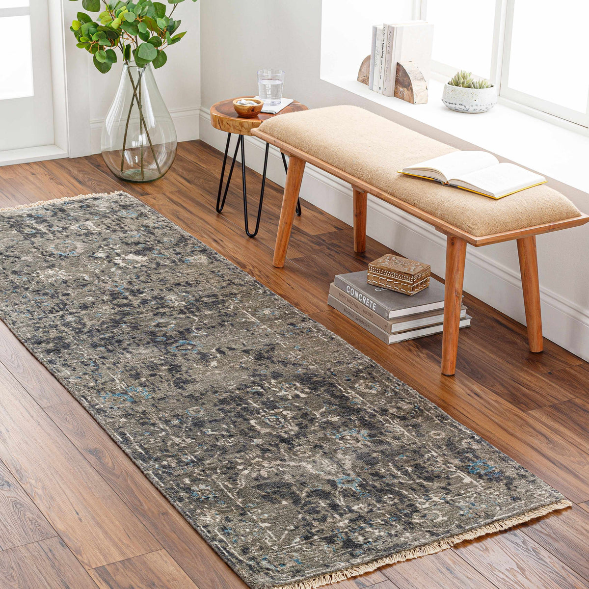 Becerril Premium Rug by Boutique Rugs, charcoal gray with blue speckles, woven texture, fringe edges on Tampa Home & Garden Store