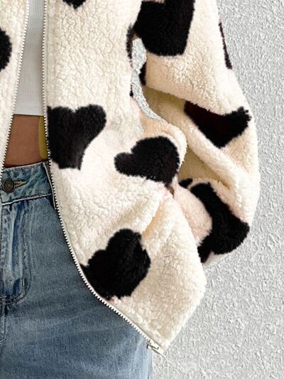 Furry cow-print zip-up jacket with drop-shoulder silhouette in cream and black on Tampa Home & Garden Store