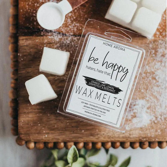Be Happy wax melts Gia Roma in a clear plastic clamshell package with orange lime lemon grapefruit bergamot scent on wooden board on Tampa Home & Garden Store