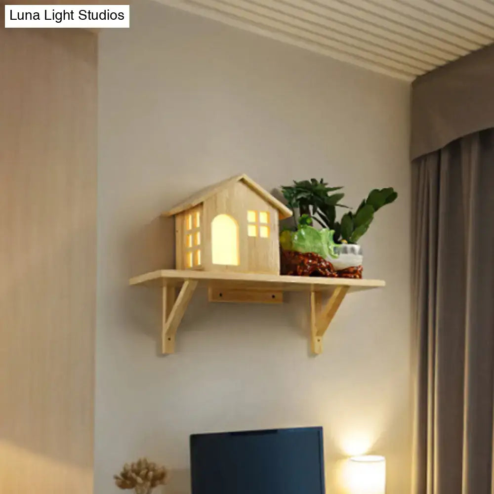 Beige wooden wall sconce with a lit house-shaped lantern and plant shelf Decorbites on Tampa Home & Garden Store