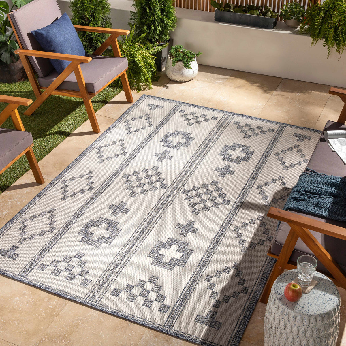 Besao Indoor & Outdoor Rug from Boutique Rugs on a patio with beige geometric motifs on Tampa Home & Garden Store