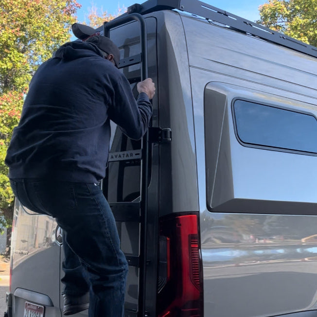 Sprinter Van Rear Ladder by Avatar Offroad on gray cargo van; climber on black ladder on Tampa Home & Garden Store