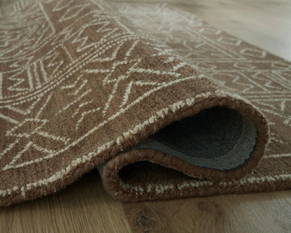 Merrittman Rug brown geometric area rug by Unique Piece Furniture folded to show underside on Tampa Home & Garden Store