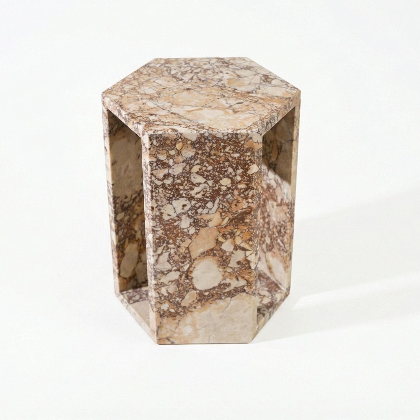 Modern hexagon side table with beige marble pattern and open rectangular side panels on Tampa Home & Garden Store