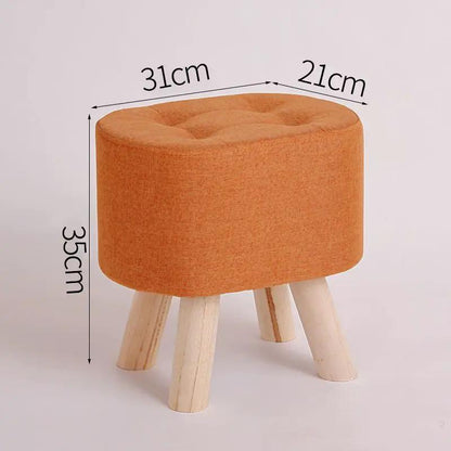Nordic fabric ottoman stool with tufted orange top and natural wood legs on Tampa Home & Garden Store