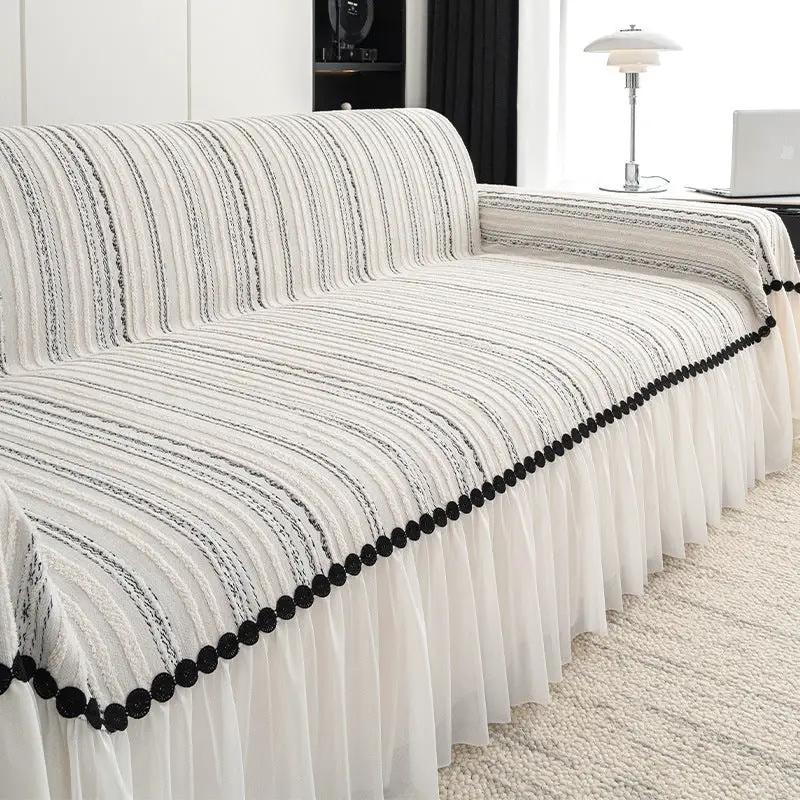 Sofa cover FLIPSTYLEZLLC with cream striped fabric, black pom-pom trim and ruffled skirt on Tampa Home & Garden Store