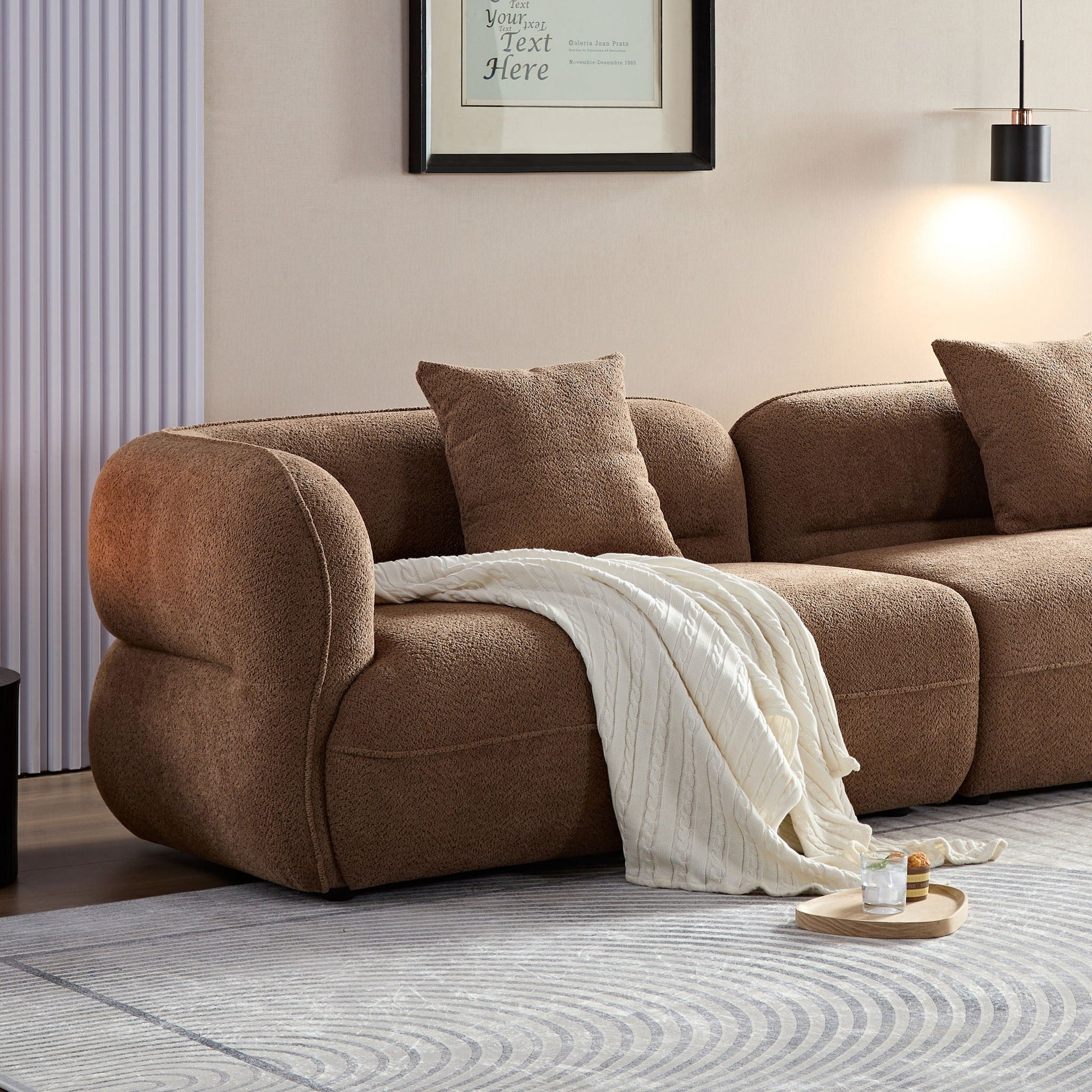 Brown sectional sofa in durable fabric with solid wood frame and white knit throw on Tampa Home & Garden Store