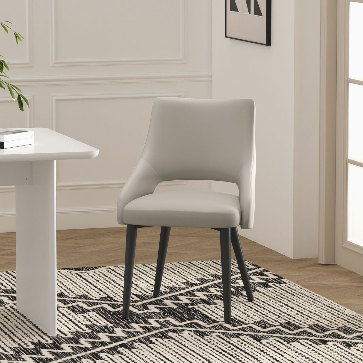 Tremont Dining Chair in gray with steel frame and curved arms, dark metal legs on Tampa Home & Garden Store
