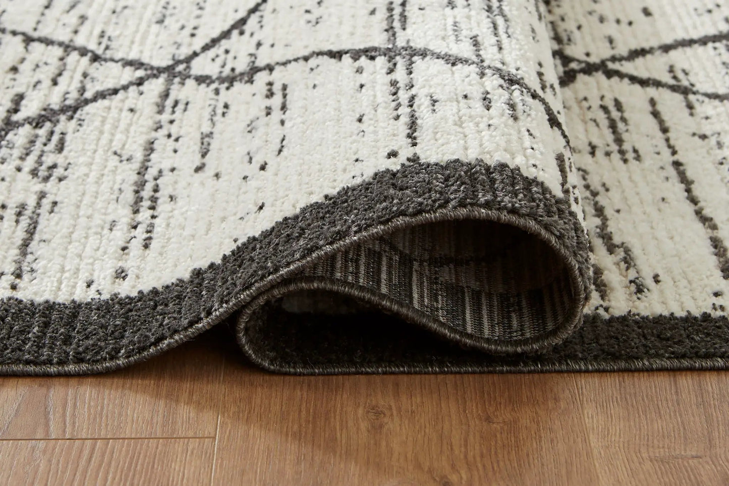 Fenriston area rug by Unique Piece Furniture, cream with black abstract lines, rolled edge on Tampa Home & Garden Store