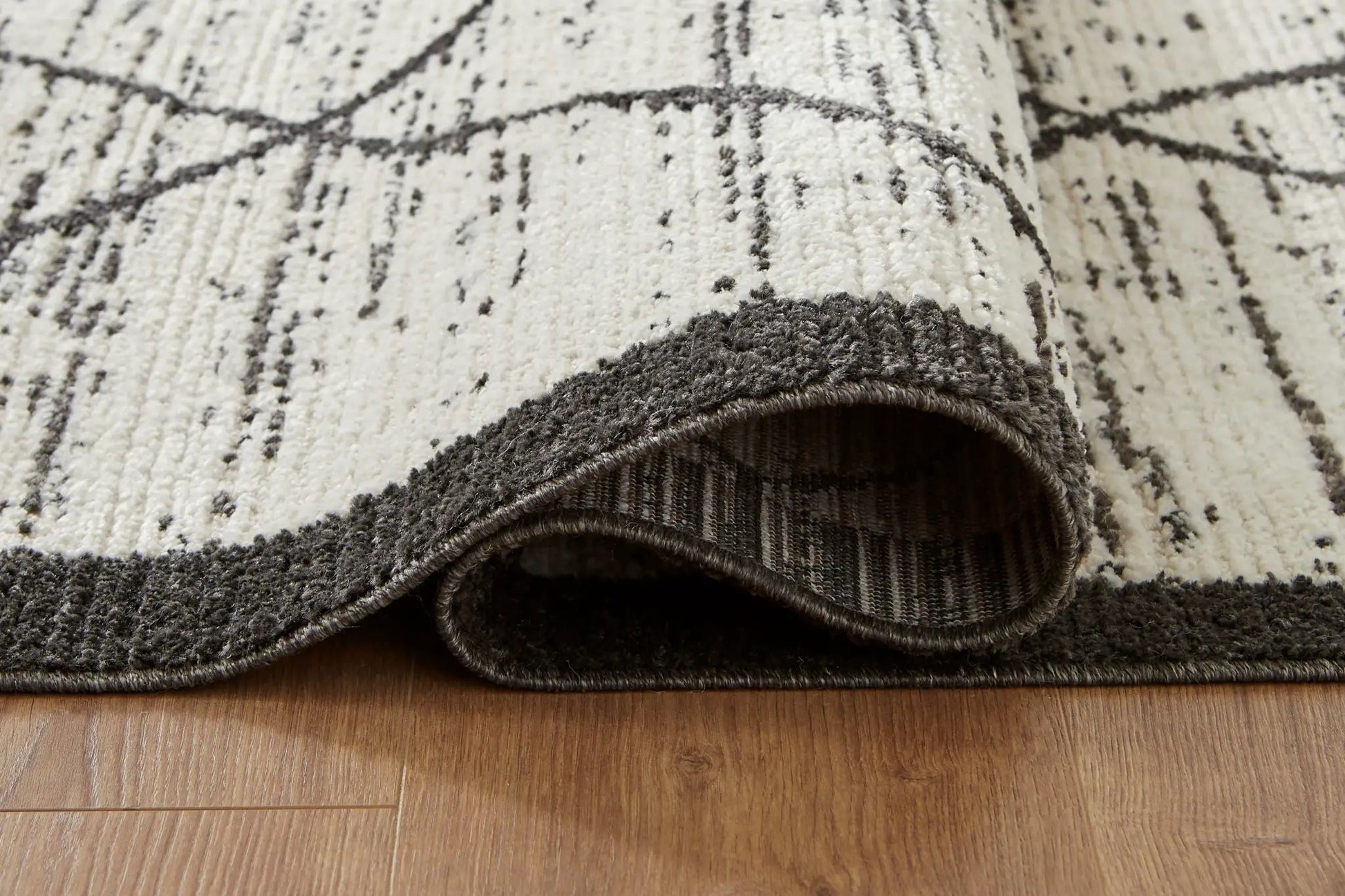 Fenriston area rug by Unique Piece Furniture, cream with black abstract lines, rolled edge on Tampa Home & Garden Store