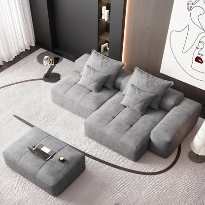 Modular sectional sofa in gray fabric with pillows in a modern living room beside a cabinet on Tampa Home & Garden Store