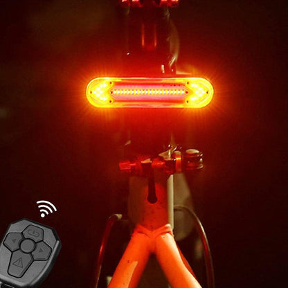 Stevvex wireless bicycle tail light and remote control, orange LED rear beacon and gray remote on Tampa Home & Garden Store