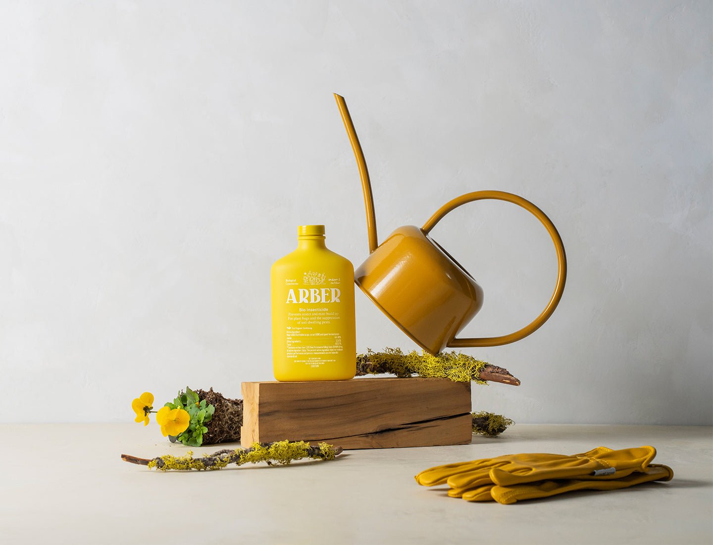 Organic Bio Insecticide bottle by Rooted Treasures Farms; yellow can plus gloves on Tampa Home & Garden Store