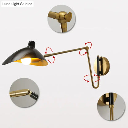 Brass adjustable wall sconce by Decorbites with black shade and articulated arms on Tampa Home & Garden Store