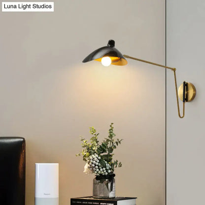 Brass Adjustable Wall Sconce with black shade and gold interior, wall-mounted on Tampa Home & Garden Store