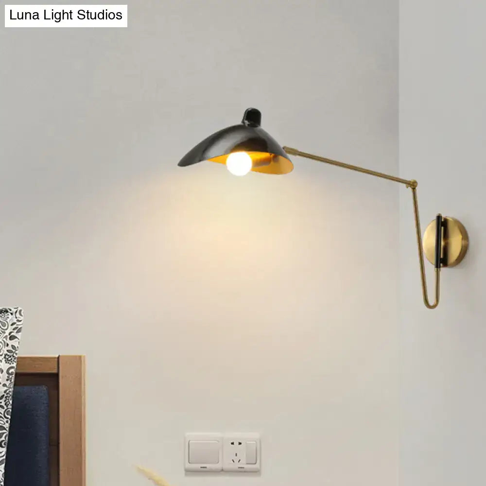 Brass adjustable wall sconce with black exterior shade and gold interior, wall-mounted arm on Tampa Home & Garden Store