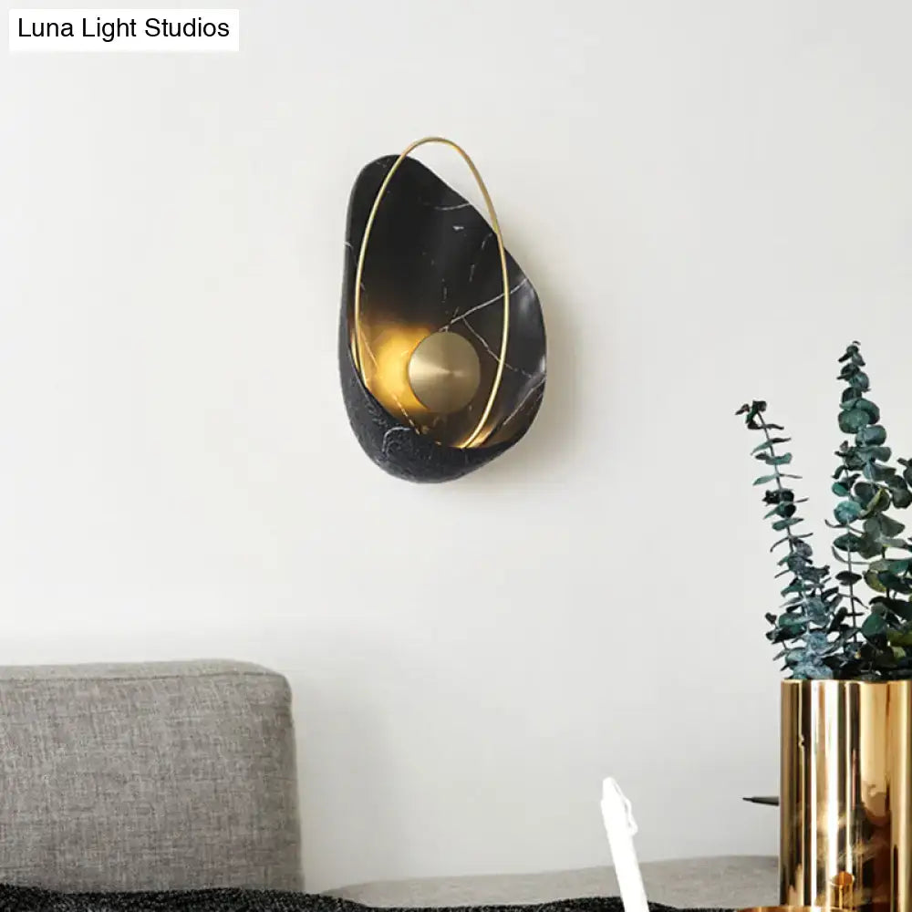 Black marble wall light sconce with a gold interior and circular gold ring on Tampa Home & Garden Store