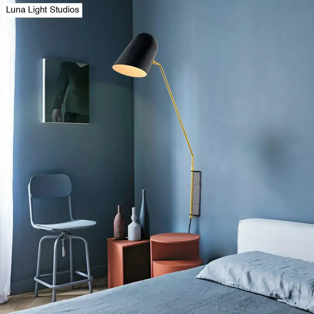 Black metal reading sconce with adjustable brass arm mounted on bedroom wall Decorbites on Tampa Home & Garden Store