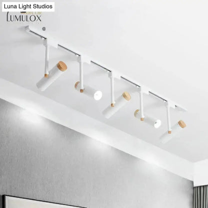 Ceiling track lighting fixture with white cylindrical heads and wood accents on Tampa Home & Garden Store