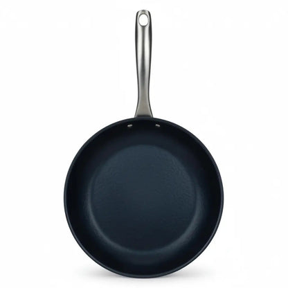 Carbon steel frying pan with dark blue interior and long metal handle on Tampa Home & Garden Store