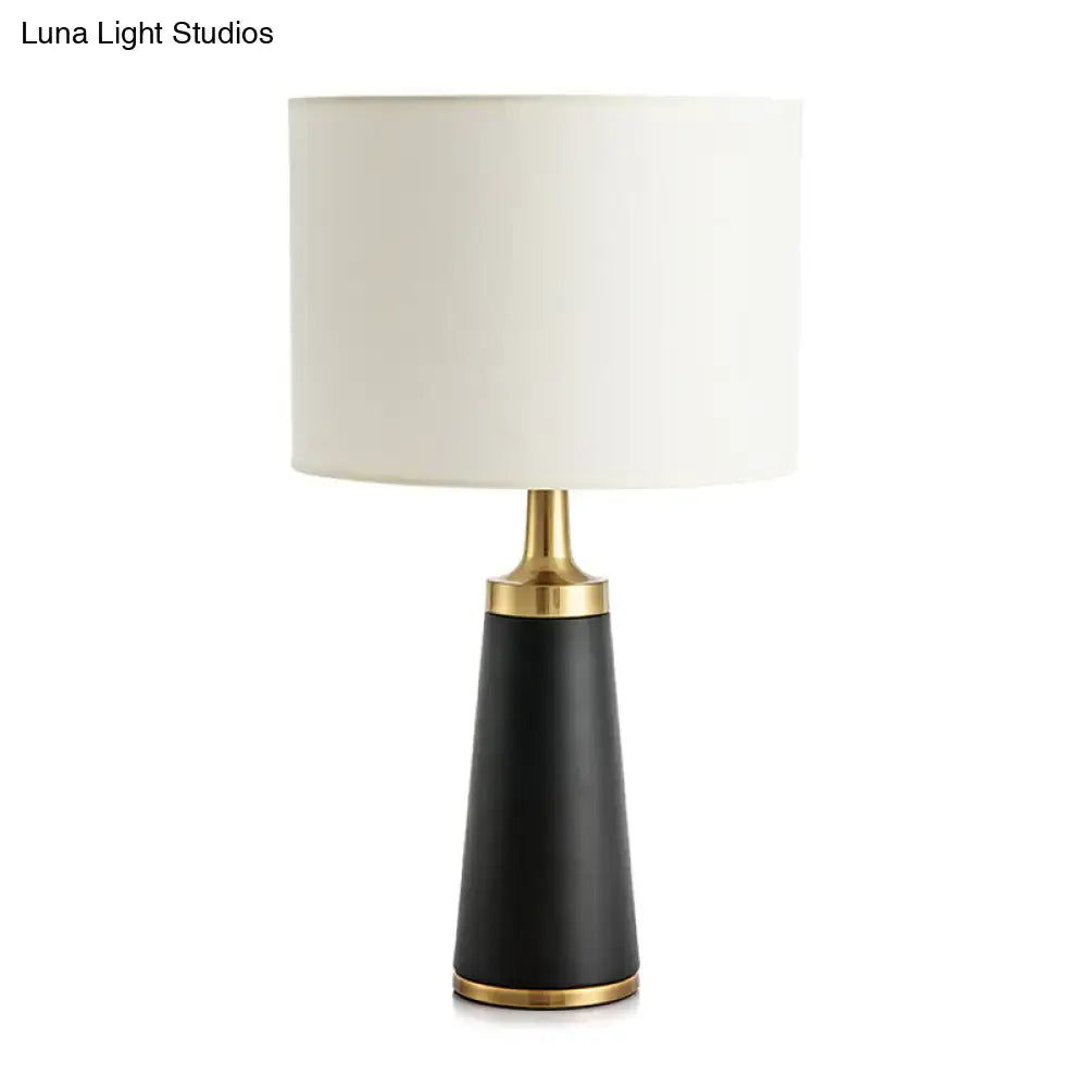 Gold Drum LED Table Lamp Decorbites, black tapered base with brass trim and white drum shade on Tampa Home & Garden Store