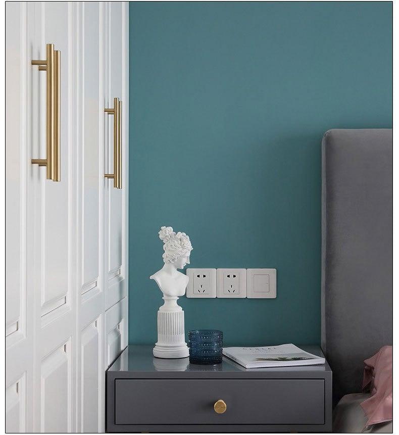 Gold brushed cabinet handles on white built-in wardrobes; two vertical pulls on Tampa Home & Garden Store