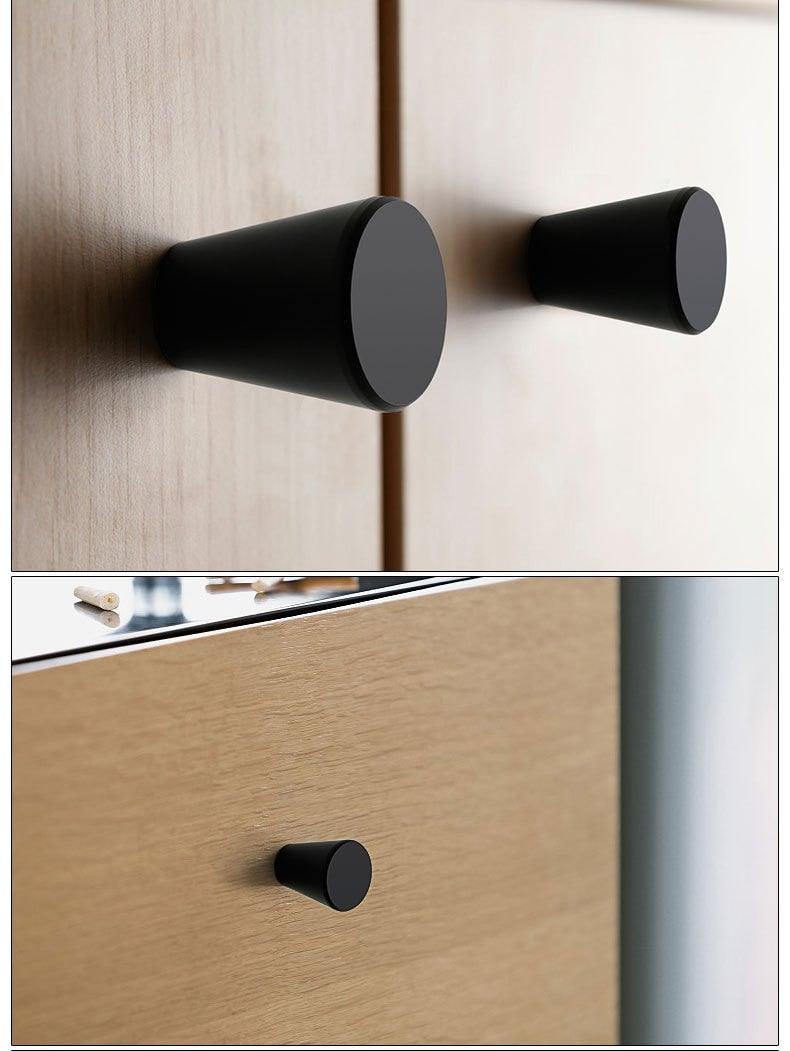 Cabinet knobs and drawer pulls, three black cabinet hardware pieces on wood cabinet on Tampa Home & Garden Store