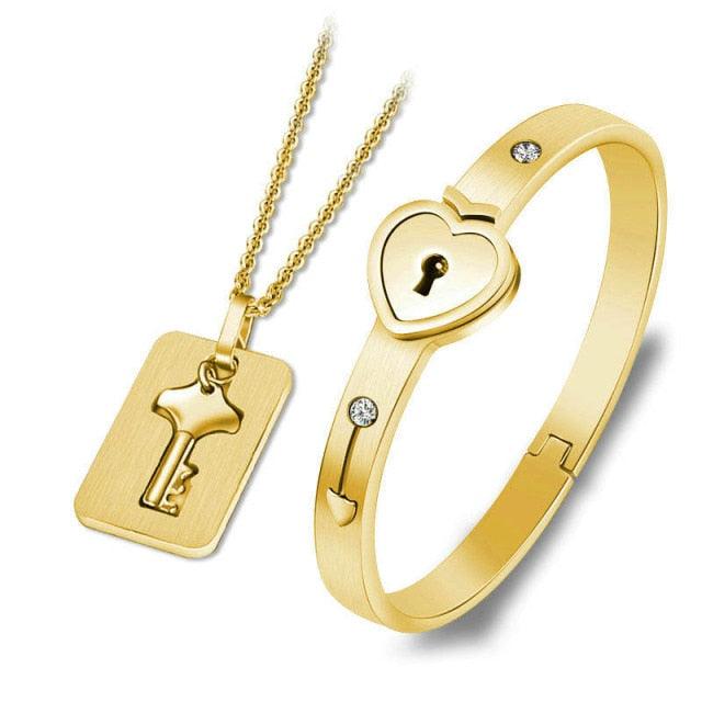Gold-tone heart lock bracelet with crystal accents and matching key pendant necklace set on Tampa Home & Garden Store