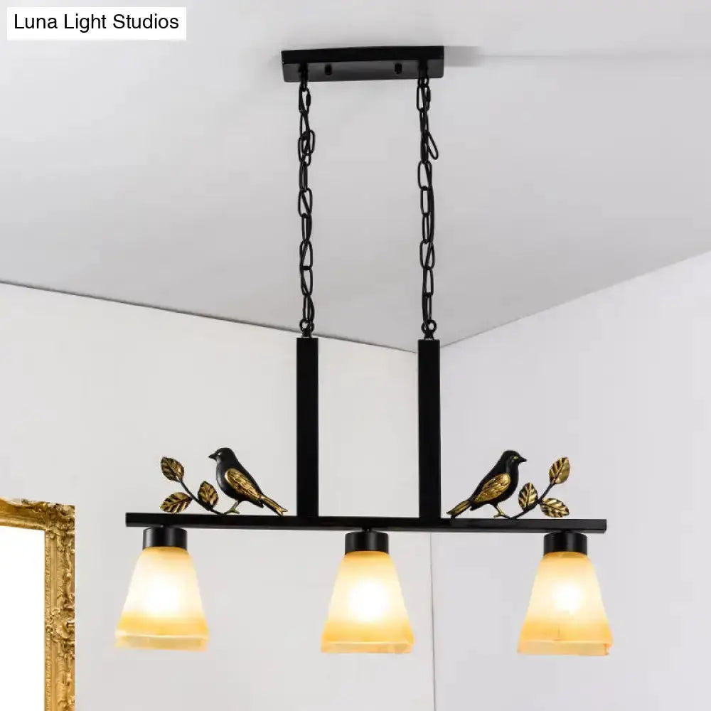 Ornate black & gold island light pendant with three amber glass shades and bird-leaf accents on Tampa Home & Garden Store