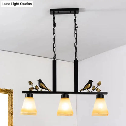 Ornate black & gold island light pendant with three amber glass shades and bird-leaf accents on Tampa Home & Garden Store