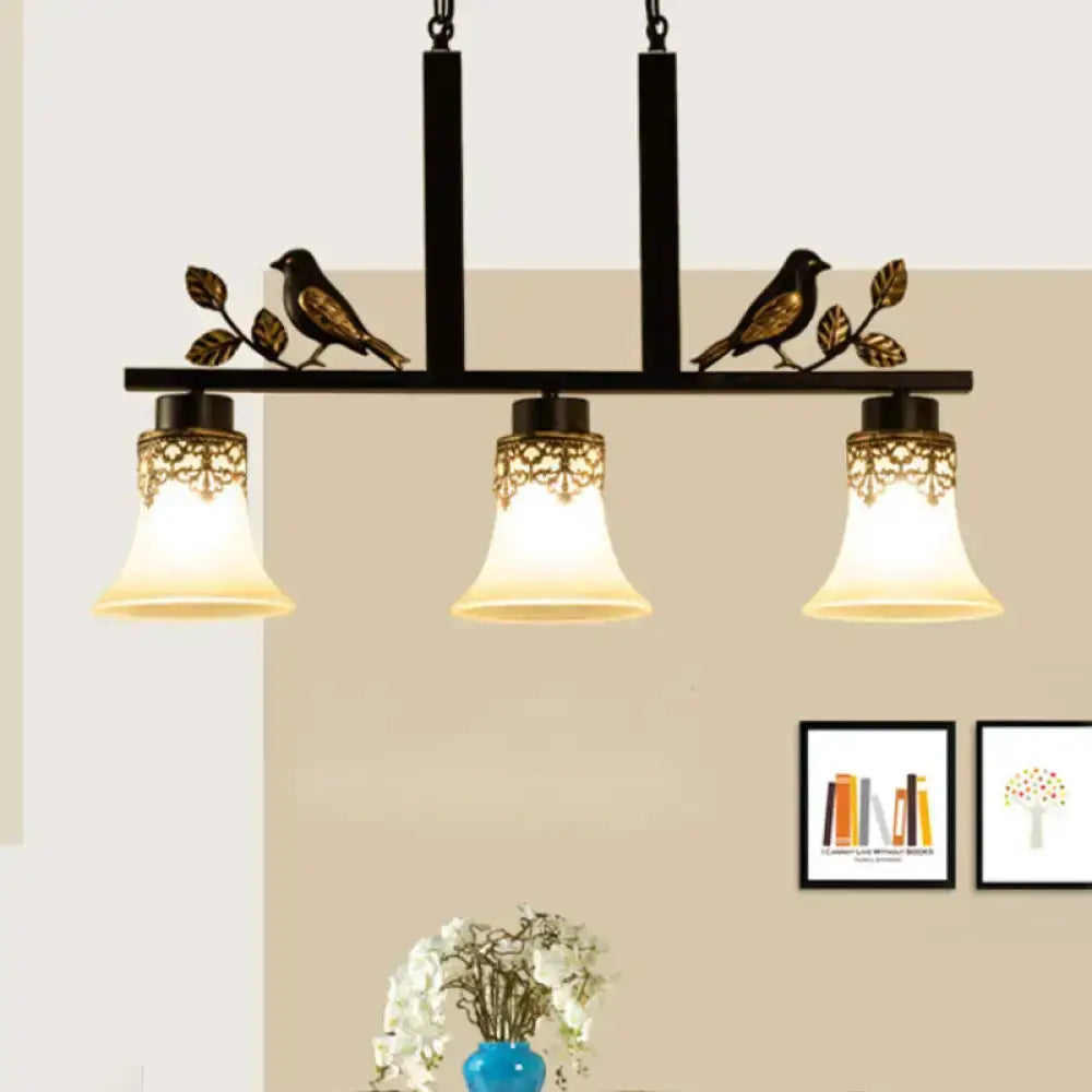 Ornate black and gold island pendant light with tan glass shades, 3-light kitchen fixture on Tampa Home & Garden Store