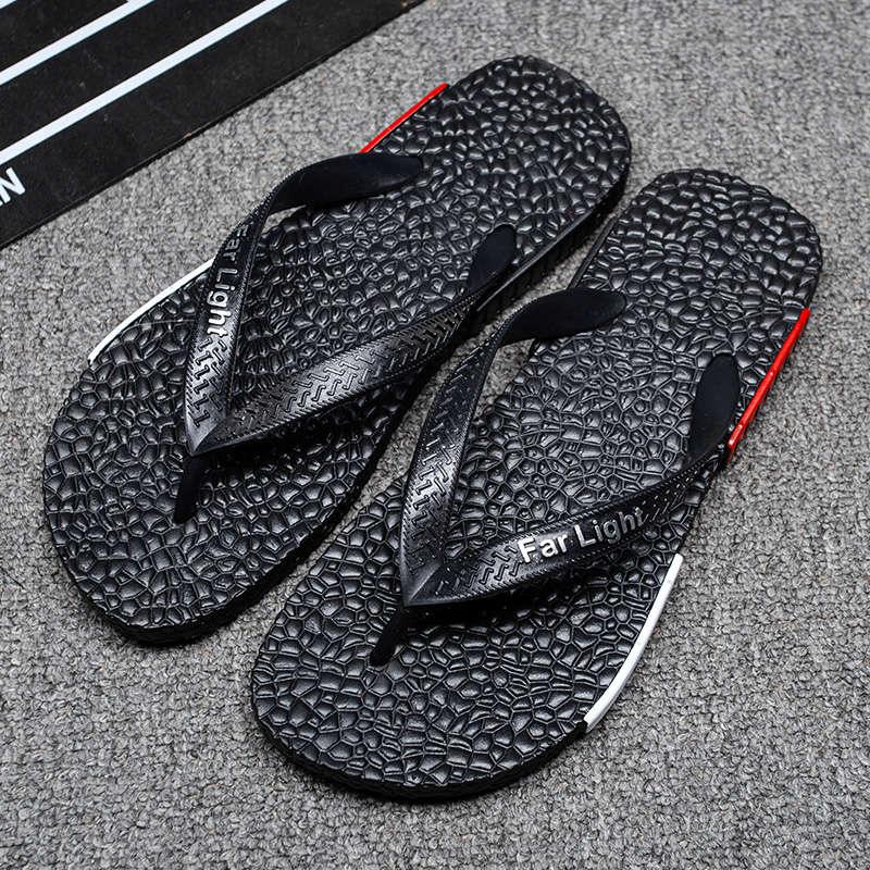 Two black men's flip flop sandals with textured footbeds and Far Light branding on straps on Tampa Home & Garden Store