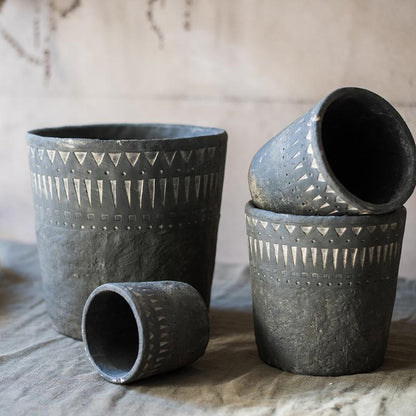 Black pottery cement planters set of four with geometric triangle and dot patterns on Tampa Home & Garden Store