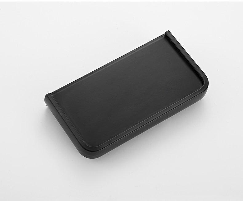 Black matte toilet paper holder with built-in bathroom shelf and adhesive mount on Tampa Home & Garden Store