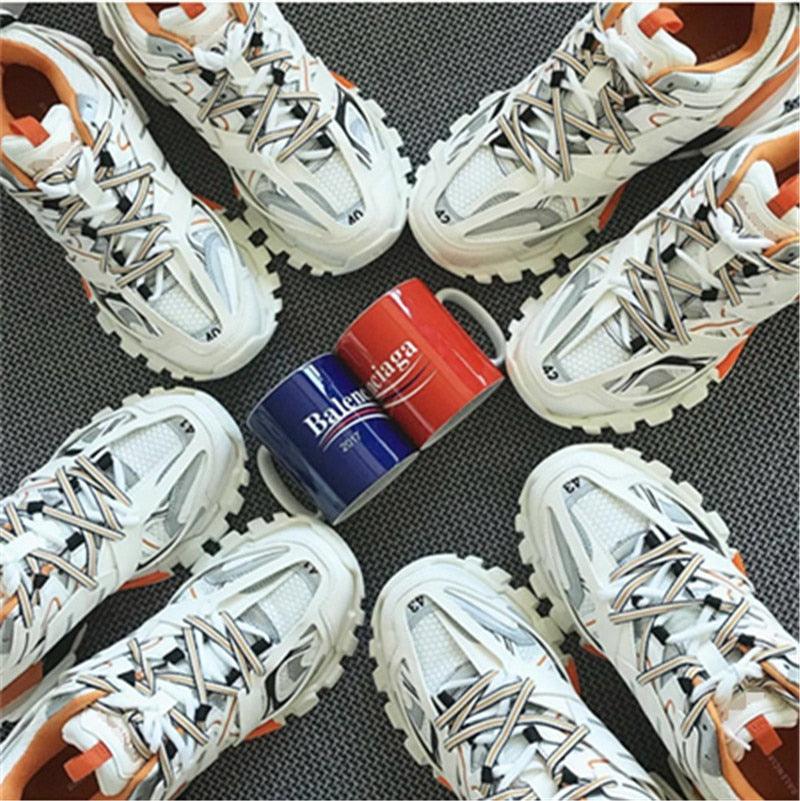 Stevvex breathable mesh sneakers white/orange, multiple pairs around Balenciaga mug on Tampa Home & Garden Store