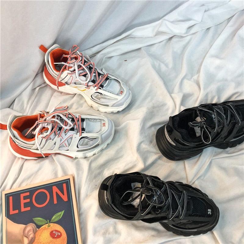 Stevvex women's breathable mesh sneakers two pairs in white/orange and black on a bed on Tampa Home & Garden Store