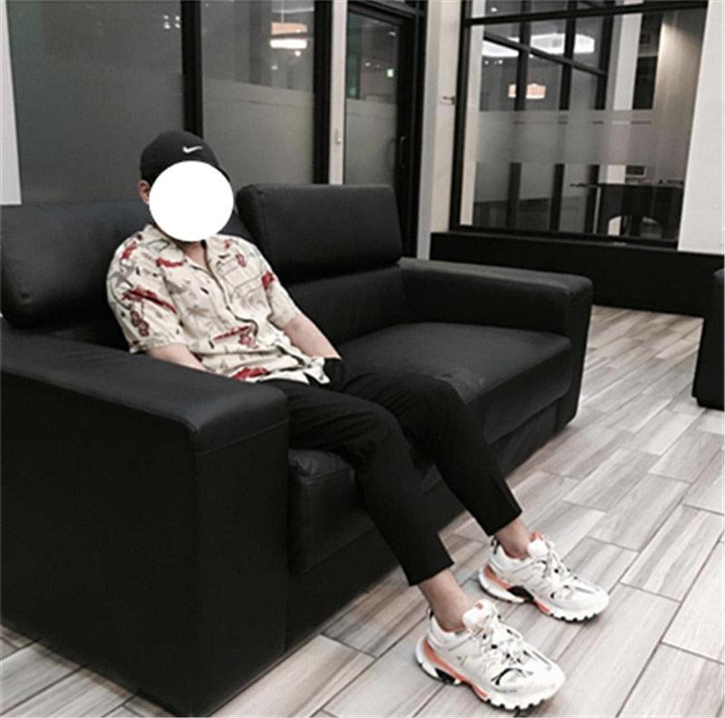 Stevvex womens breathable sneakers white mesh with orange accents worn by person on black sofa on Tampa Home & Garden Store